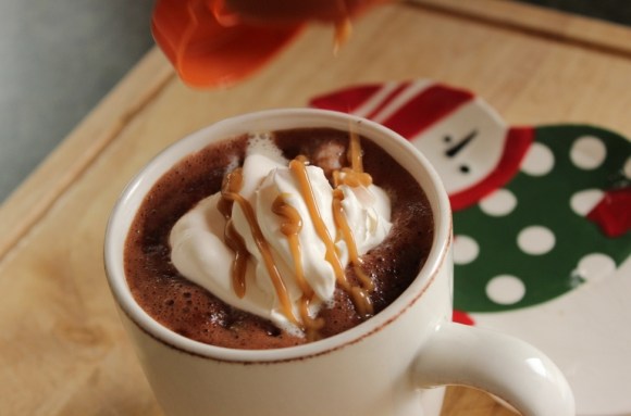 Creamy Caramel Hot Chocolate with whipped cream and caramel sauce on top!