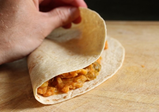 Fold quesadilla into a half moon shape before cooking in skillet. Folding Sweet Potato Quesadilla