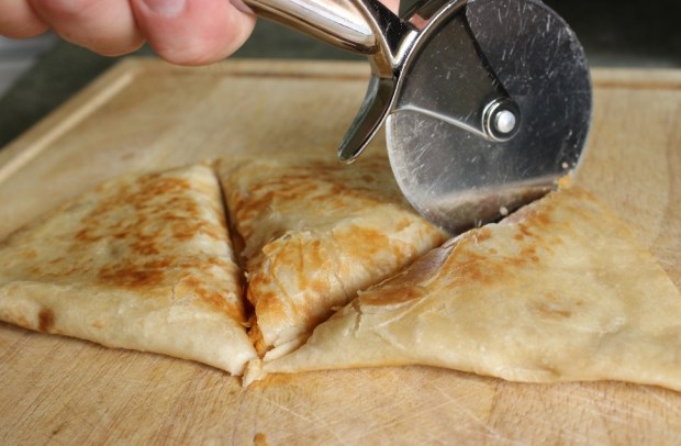 Cut quesadilla with a pizza cutter. You have one of those, right? How to Cut Sweet Potato Quesadilla