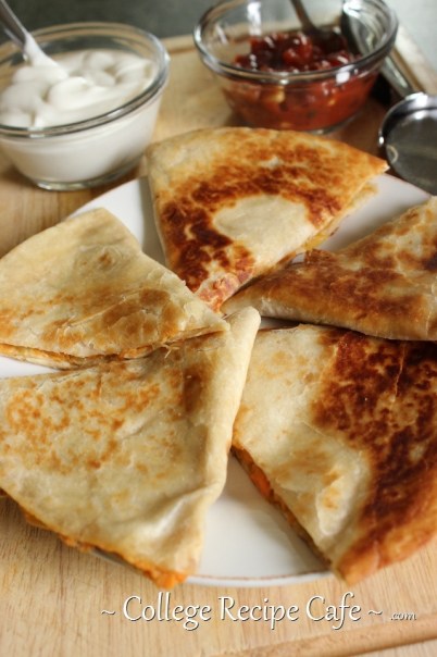 Sweet potato quesadilla ready for dipping into sour cream and salsa. Sweet Potato Quesadilla with salsa and sour cream