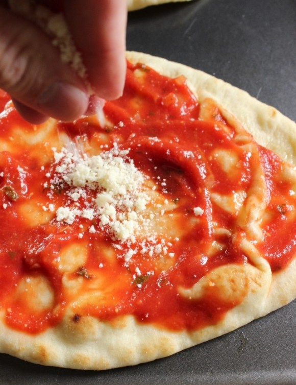 The secret to extra tasty pizza...a sprinkle of Parmesan!