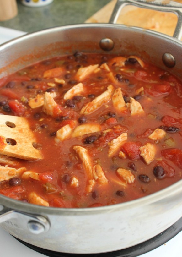 This Chicken Tortilla Soup is absolutely awesome served on a bed of tortilla chips and topped with shredded cheese!
