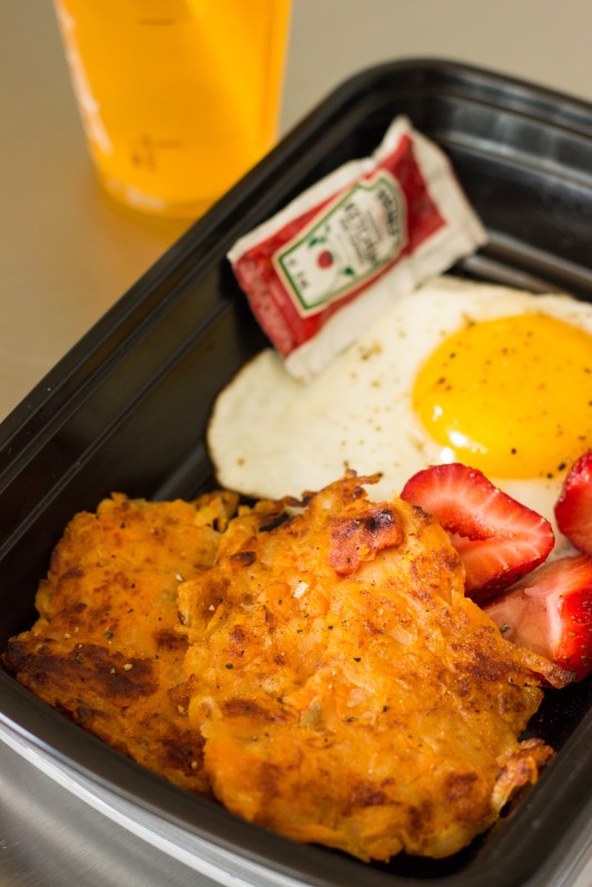 Sweet Potato Hash Browns Served with Fried Eggs and Sliced Strawberries